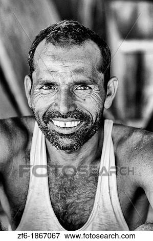 Colorful portrait of local Hindu man with great smile in small village of Charu near Ranthambore in Rajasthan India View Large Photo Image Stock Photo - Colorful portrait of local Hindu man with great smile in small village of Charu near Ranthambore in Rajasthan India. Fotosearch