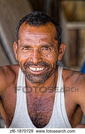 Colorful portrait of local Hindu man with great smile in small village of Charu near Ranthambore in Rajasthan India View Large Photo Image Stock Photo - Colorful portrait of local Hindu man with great smile in small village of Charu near Ranthambore in Rajasthan India. Fotosearch