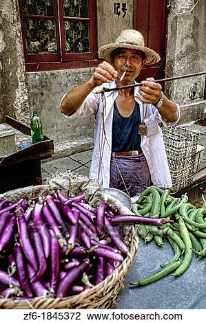 Colorful portrait of man selling vegetables on the streets of Shanghai China. View Large Photo Image Stock Image - Colorful portrait of man selling vegetables on the streets of Shanghai China.. Fotosearch