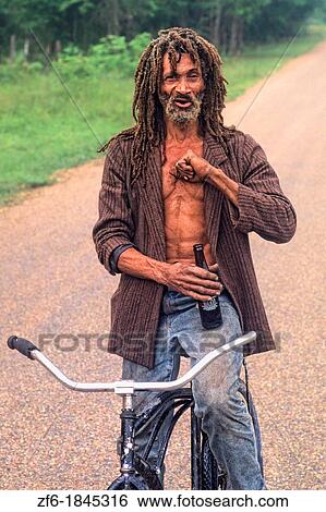 Stock Photograph - Colorful portrait of native man with dreadlocks in Belize. Fotosearch