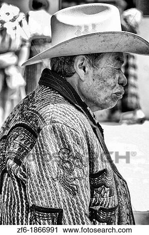 Stock Image - Colorful print patterned clothes of men in the famous market day color of the Highlands in village of Solola Guatemala. Fotosearch