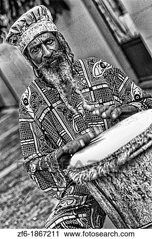 Colorful Rasta Jamaican Reggae performer on drum in costume at Harbour in St John Antigua View Large Photo Image Stock Image - Colorful Rasta Jamaican Reggae performer on drum in costume at Harbour in St John Antigua. Fotosearch