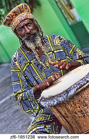 Colorful Rasta Jamaican Reggae performer on drum in costume at Harbour in St John Antigua View Large Photo Image Stock Photo - Colorful Rasta Jamaican Reggae performer on drum in costume at Harbour in St John Antigua. Fotosearch