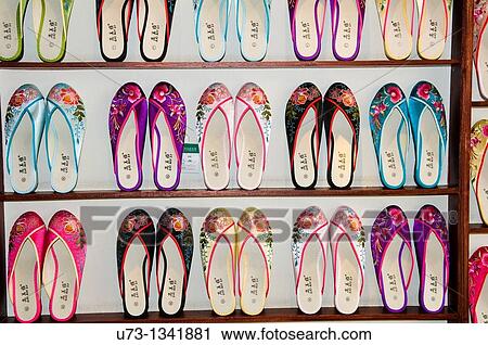 Stock Image - Colorful traditional Chinese shoes sold in a souvenir shop in Purple mountain in Nanjing.. Fotosearch