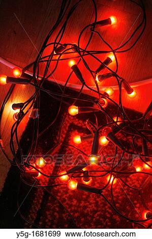Stock Photo - colourful christmas fairy lights on living room floor. Fotosearch