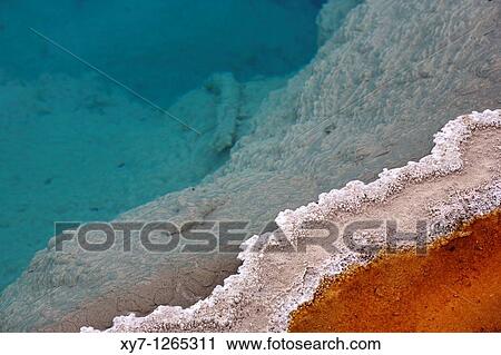 Stock Image - Colourful mineral deposits at Black Pool hot spring in Yellowstone National Park in Wyoming, United States. Fotosearch