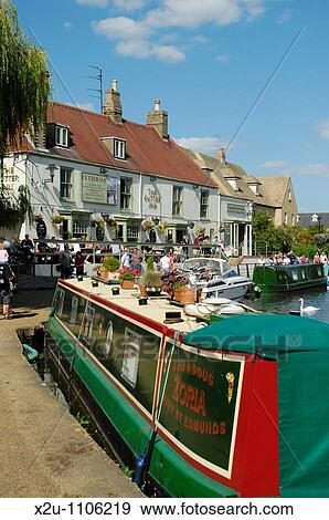 Colourful narrowboat moored near the Cutter Inn on the River Great Ouse, Ely, Cambridgeshire, England View Large Photo Image Stock Photo - Colourful narrowboat moored near the Cutter Inn on the River Great Ouse, Ely, Cambridgeshire, England. Fotosearch