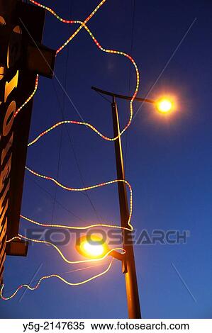 Colourful strip lights wound around street lamp in city town View Large Photo Image Stock Photography - Colourful strip lights wound around street lamp in city town. Fotosearch