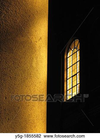 Stock Image - column and window inside dark church in rome italy. Fotosearch