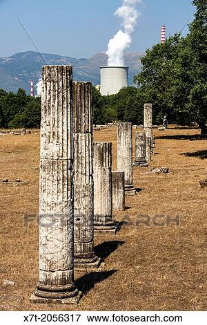 Columns from the ruins of Ancient Megalopolis with the cooling tower and chimney of Mergalopoli's modern power station in the background. Central Peloponnese, Greece. View Large Photo Image Stock Photo - Columns from the ruins of Ancient Megalopolis with the cooling tower and chimney of Mergalopoli's modern power station in the background. Central Peloponnese, Greece.. Fotosearch