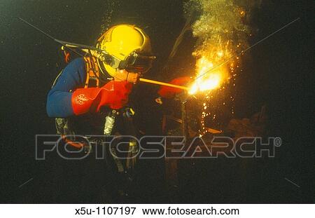 Stock Photo - Commercial diver welding underwater. Fotosearch