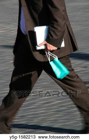 commuter businessman with ipad computer walking in city town View Large Photo Image Stock Image - commuter businessman with ipad computer walking in city town. Fotosearch