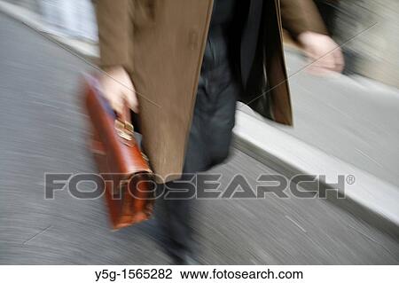 Stock Image - commuter with briefcase in town in rome italy. Fotosearch