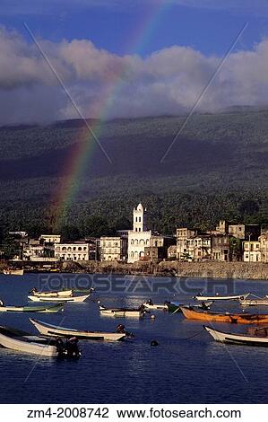 Stock Image - COMORO ISLANDS, GRAND COMORE, MORONI, VIEW OF TOWN WITH FISHING BOATS IN FOREGROUND, RAINBOW.. Fotosearch