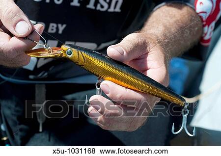 Stock Photo - Competitors in timor-Leste's first sport fishing competition, many were international and had travelled from Darwin, NT Australia a lure designed to skip along just under the surface and tempt fast moving fish like tuna to strike. Fotosearch