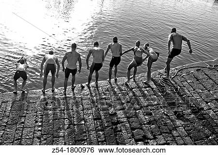 Competitors jumping into water at Gij? n Marina, in a swimming race, Asturias, Spain View Large Photo Image Stock Photograph - Competitors jumping into water at Gij? n Marina, in a swimming race, Asturias, Spain. Fotosearch