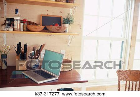 Stock Photo - Computer laptop in kitchen. Fotosearch