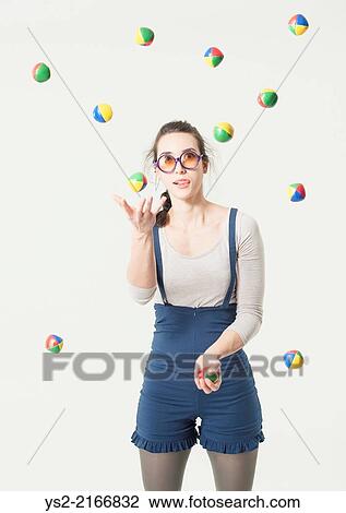 Concentrated young hispanic woman with glasses juggling with many balls. View Large Photo Image Stock Image - Concentrated young hispanic woman with glasses juggling with many balls.. Fotosearch