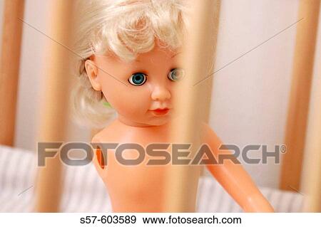 Concept _ baby doll with removed hand in child crib View Large Photo Image Stock Photo - Concept _ baby doll with removed hand in child crib. Fotosearch
