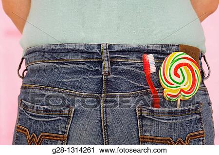 concept, back view of young woman wearing blue jeans, with in her back pocket a red tooth brush and a multicolored lollipop View Large Photo Image Stock Image - concept, back view of young woman wearing blue jeans, with in her back pocket a red tooth brush and a multicolored lollipop. Fotosearch