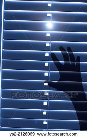 Conceptual image of being trapped and helpless. Shadow of a hand reaching for closed window blinds with sunlight outside. View Large Photo Image Stock Photo - Conceptual image of being trapped and helpless. Shadow of a hand reaching for closed window blinds with sunlight outside.. Fotosearch