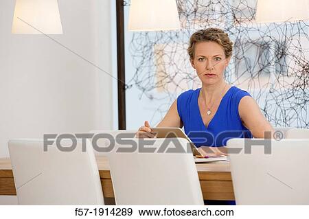 Confident young businesswoman working View Large Photo Image Stock Photo - Confident young businesswoman working. Fotosearch
