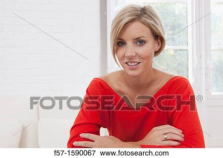 Confident young women in her apartment View Large Photo Image Stock Photo - Confident young women in her apartment. Fotosearch