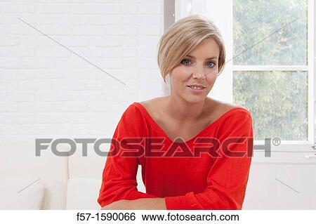 Confident young women in her apartment View Large Photo Image Stock Photograph - Confident young women in her apartment. Fotosearch