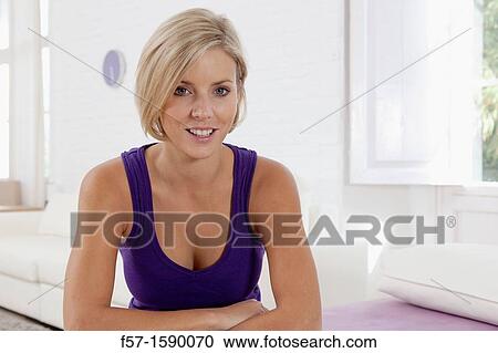 Stock Image - Confident young women in her loft apartment. Fotosearch
