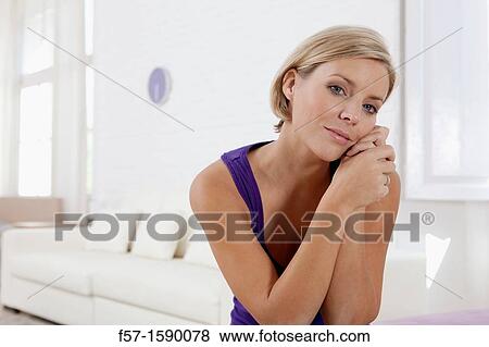 Confident young women in her loft apartment View Large Photo Image Stock Photo - Confident young women in her loft apartment. Fotosearch