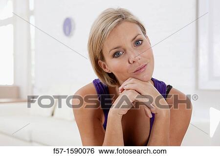 Confident young women in her loft apartment View Large Photo Image Stock Photograph - Confident young women in her loft apartment. Fotosearch