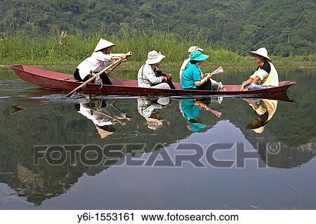 Conical hat boat woman rows visitors to Perfume Pagoda Vietnam View Large Photo Image Stock Image - Conical hat boat woman rows visitors to Perfume Pagoda Vietnam. Fotosearch