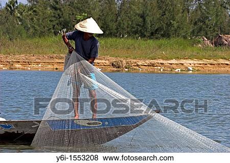 Conical hat man hand casting net fishing Thu Bon River in Hoi An historic town mid Vietnam View Large Photo Image Stock Photo - Conical hat man hand casting net fishing Thu Bon River in Hoi An historic town mid Vietnam. Fotosearch