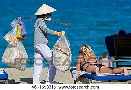 Conical hat woman selling snacks on beach Nha Trang resort Vietnam View Large Photo Image Stock Photography - Conical hat woman selling snacks on beach Nha Trang resort Vietnam. Fotosearch