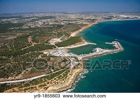 Conil de la Fontera's harbour at Cabo Roche beach and cliff Fuente el Gallo Conil de la Frontera behind Vejer de la Frontera in the background CBdiz area Spain. View Large Photo Image Stock Image - Conil de la Fontera's harbour at Cabo Roche beach and cliff Fuente el Gallo Conil de la Frontera behind Vejer de la Frontera in the background CBdiz area Spain.. Fotosearch