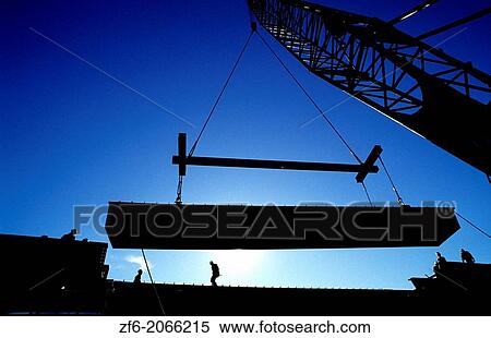 Construction Crane lifting heavy I beam into place. View Large Photo Image Stock Photography - Construction Crane lifting heavy I beam into place.. Fotosearch