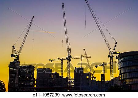 Stock Photo - construction cranes at dusk, london, england, uk, europe.. Fotosearch