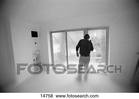 Construction foreman speaking on walkie-talkie View Large Photo Image Stock Photo - Construction foreman speaking on walkie-talkie. Fotosearch
