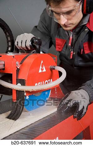 Stock Image - Construction machinery, cutting table with diamond blade. Fotosearch