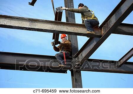 Construction steel workers erecting steel I beams View Large Photo Image Stock Photo - Construction steel workers erecting steel I beams. Fotosearch
