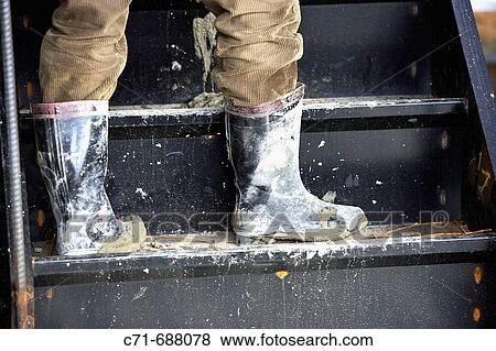 Construction worker boots messed with concrete View Large Photo Image Stock Photo - Construction worker boots messed with concrete. Fotosearch
