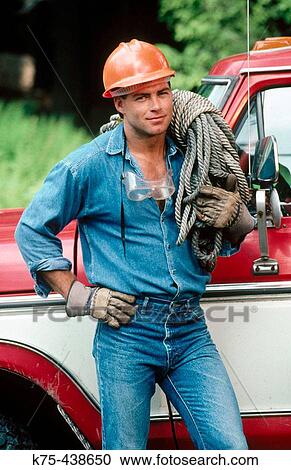 Stock Image - construction worker by his pick-up truck. Fotosearch