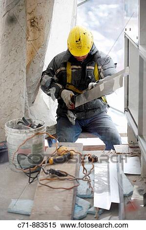 Construction worker cutting tin View Large Photo Image Stock Photography - Construction worker cutting tin. Fotosearch