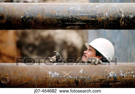 Construction worker in trench between pipes. View Large Photo Image Stock Image - Construction worker in trench between pipes.. Fotosearch