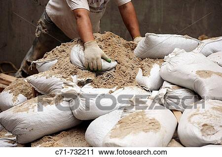 Construction worker moving sand bags View Large Photo Image Stock Image - Construction worker moving sand bags. Fotosearch