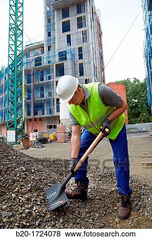 Construction worker shoveling, hand tools for construction, Housing Construction, Basque Country, Spain View Large Photo Image Stock Photo - Construction worker shoveling, hand tools for construction, Housing Construction, Basque Country, Spain. Fotosearch