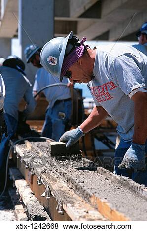Construction worker smoothing concrete, Denver, CO, USA View Large Photo Image Stock Photo - Construction worker smoothing concrete, Denver, CO, USA. Fotosearch