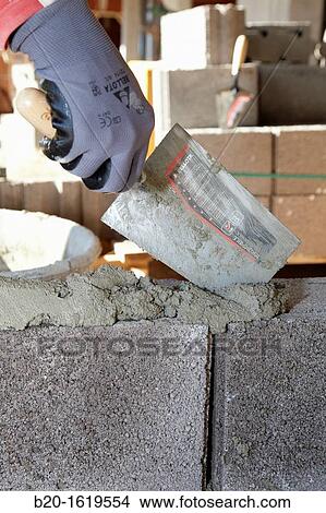 Construction worker using mortar with a trowel, Building hand tool, Donostia, San Sebastian, Gipuzkoa, Basque Country, Spain View Large Photo Image Picture - Construction worker using mortar with a trowel, Building hand tool, Donostia, San Sebastian, Gipuzkoa, Basque Country, Spain. Fotosearch