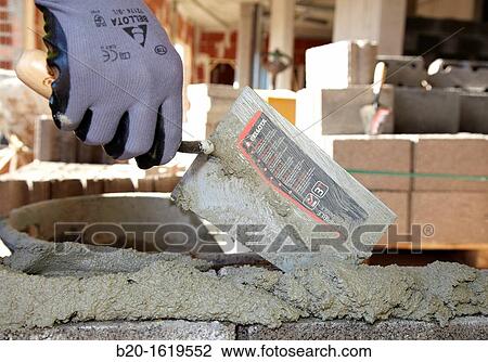 Construction worker using mortar with a trowel, Building hand tool, Donostia, San Sebastian, Gipuzkoa, Basque Country, Spain View Large Photo Image Stock Image - Construction worker using mortar with a trowel, Building hand tool, Donostia, San Sebastian, Gipuzkoa, Basque Country, Spain. Fotosearch