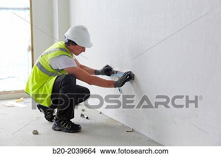 Construction worker with a level. Construction of residential building. Donostia. San Sebastian. Gipuzkoa. Basque Country. Spain. View Large Photo Image Picture - Construction worker with a level. Construction of residential building. Donostia. San Sebastian. Gipuzkoa. Basque Country. Spain.. Fotosearch